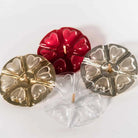 Four candles with heart shared molding in gold, red, and silver, arranged on a plain white background.